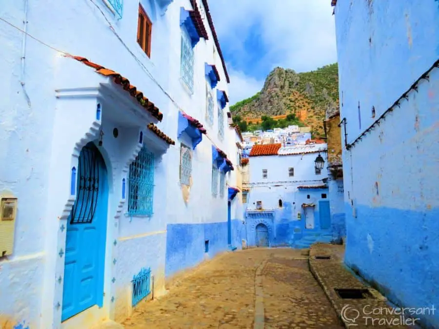 Blue painted houses along a cobbled street