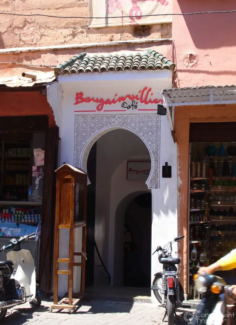 Outside of cafe entrance with motorbikes in the street