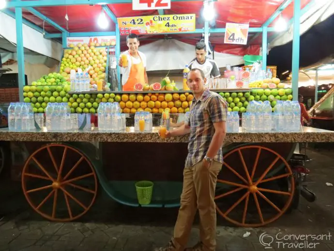 Cart piled high with oranges, selling juice to tourists