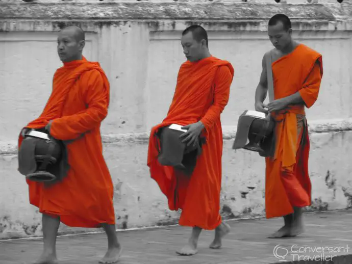 Things to do in Luang Prabang - monks receiving morning alms or Tak Bat