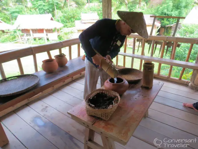 Sia Lee testing to see if the rice is good quality, Living Land Rice Farm