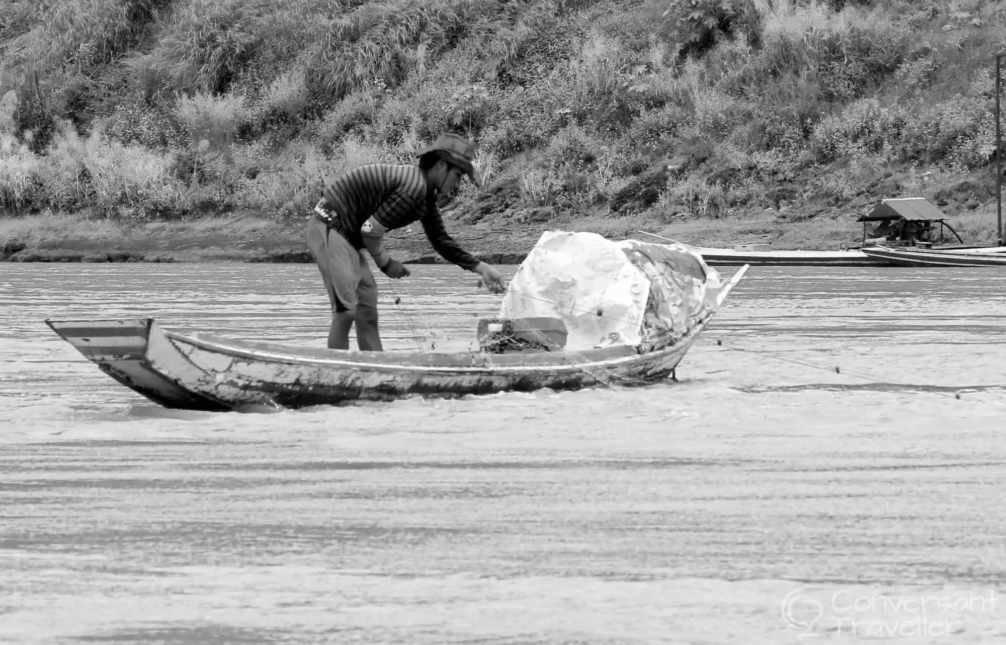 Fisherman hunting for dinner on the mightly Mekong,Laos