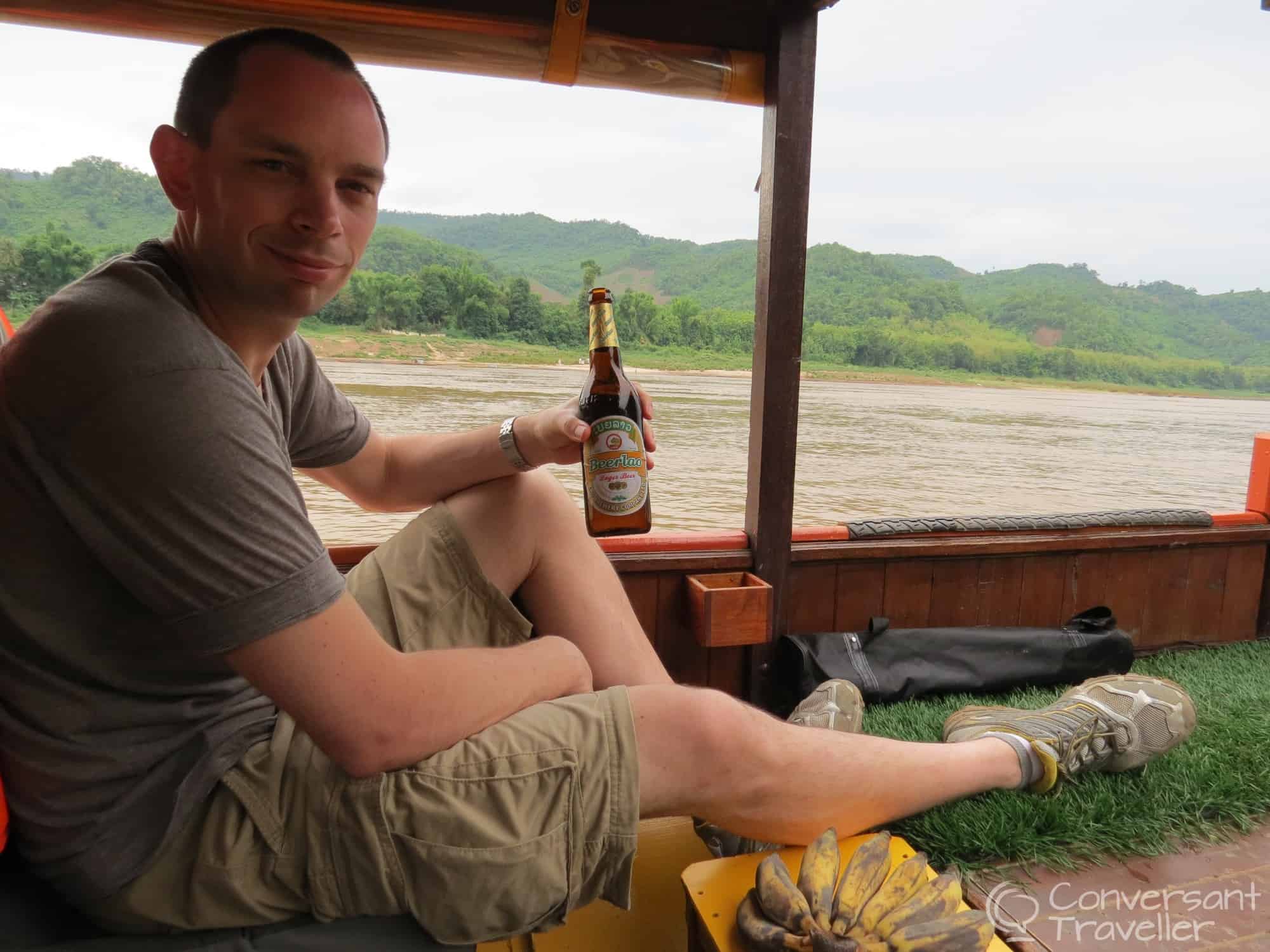 Hubbie enjoying a well-earned Beer Lao on board the Banana Boat