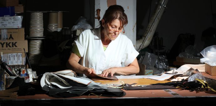 Hard at work in the leather factory (image courtesy of Maxwell Scott Bags)