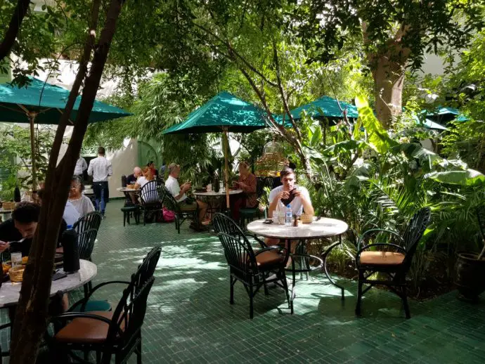 Courtyard with tables surrounded by trees