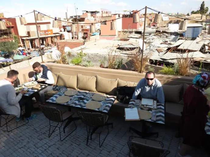 Roof terrace restaurant in Marrakech overlooking a small square with market stalls