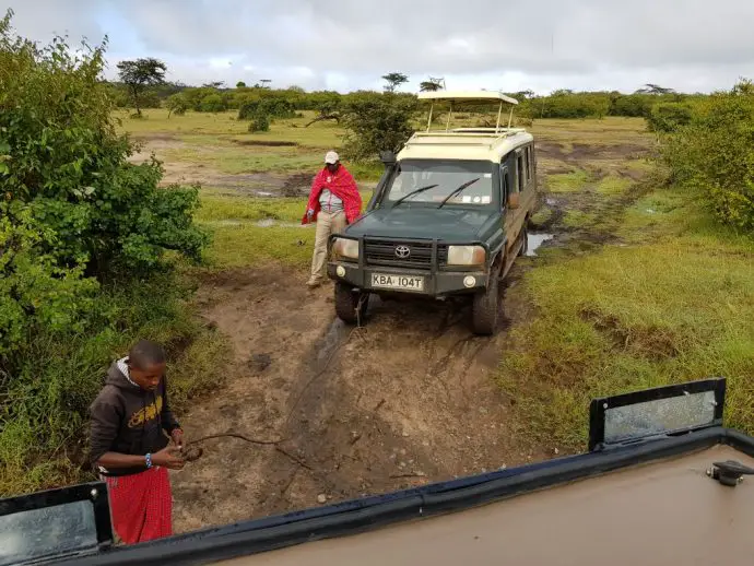 Towing a vehicle out of the mud in Naboisho Conservancy - Kenya safari with Hemingways Ol Seki