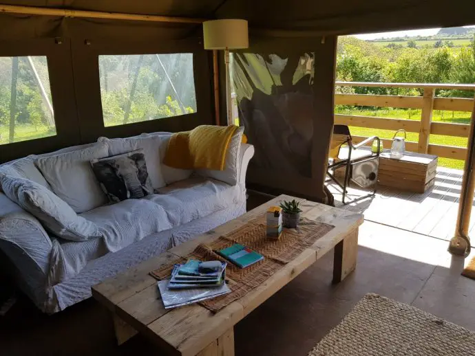 Sofa and lounge area inside the Tembo tent at Wrinklers Wood Glamping