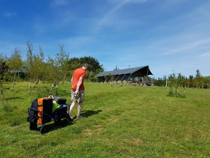Carrying the luggage on a trailer up to the tent