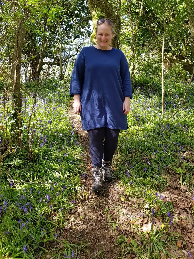 Person walking through bluebell woods