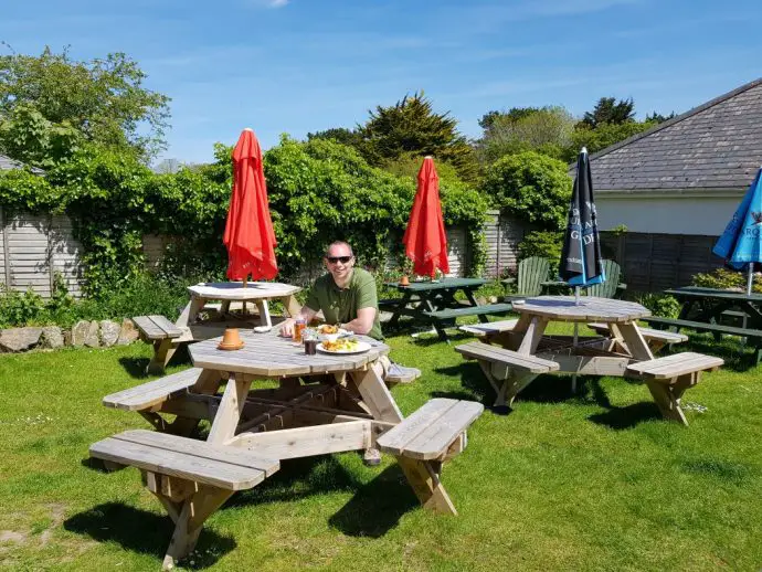 Eating a pub lunch in a beer garden at picnic benches