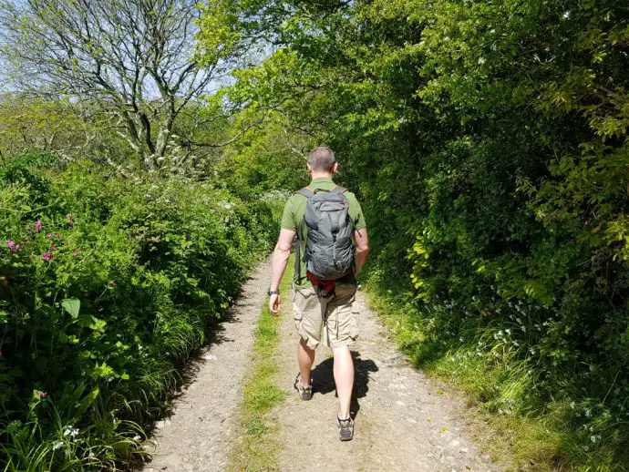 Walking down a country lane with high hedges