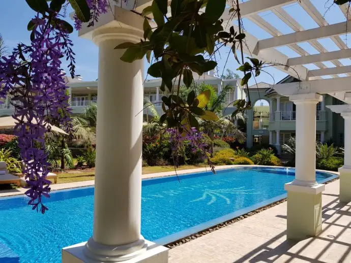 Wisteria draped decking by the pool at Hemingways Nairobi