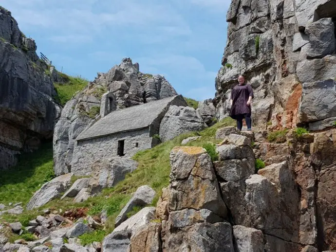 Stone chapel hidden in steep cliffs with crags either side - Glamping in Wales