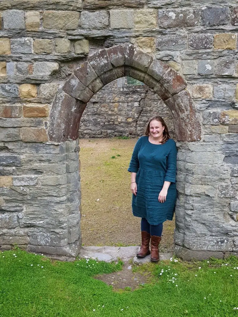 Woman standing in a stone archway