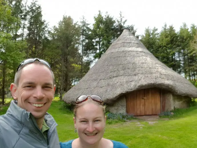 Two people in front of a roundhouse - unusual places to stay in Cornwall