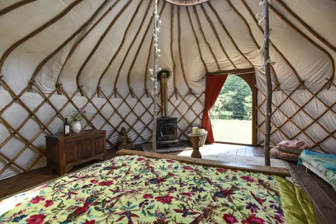 Lake District Glamping yurt - view on the inside with a bed and wood stove