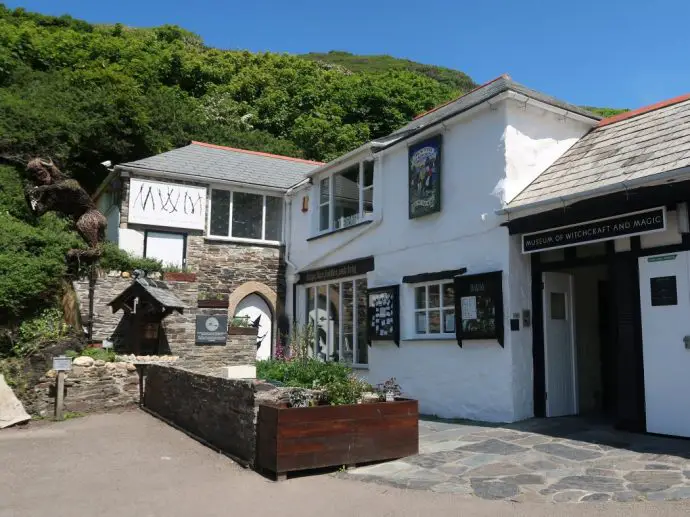 White building with sign saying Museum of Witchcraft - unusual things to do in Cornwall