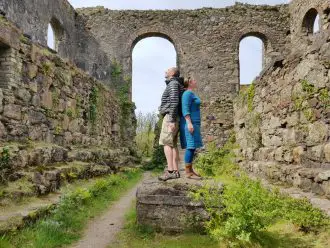 Ruined stone mine building with 2 people standing in the centre