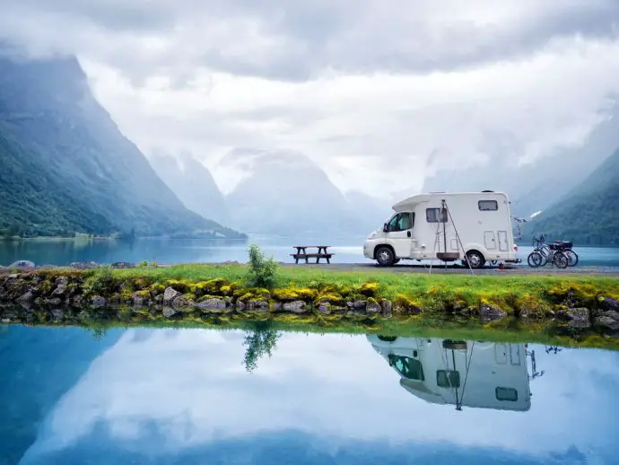 campervan beside lake in the mountains