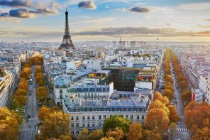 Aerial view of Paris with tree-line avenues and white buildings