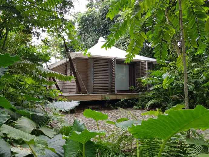 Tented cabin exterior hidden in the woods - Review of Sundy Praia Luxury Beach Lodge on Principe