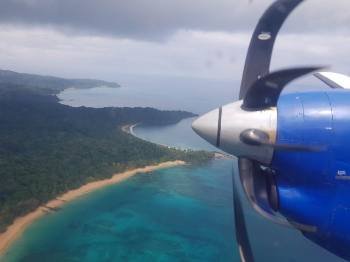 Aerial view of tropical island with long beach and rainforest