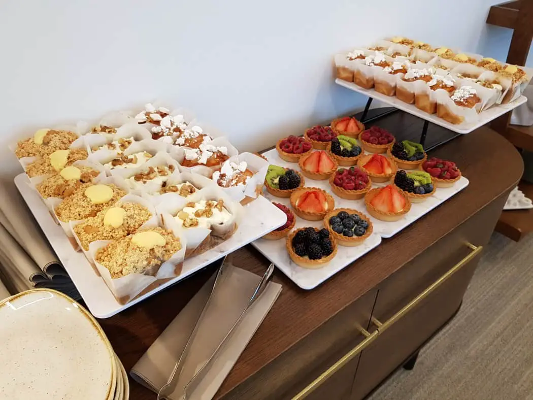 Cakes and fruit tarts at luxury Manchester airport lounge, PremiAir Small cakes and fruit tarts on a table