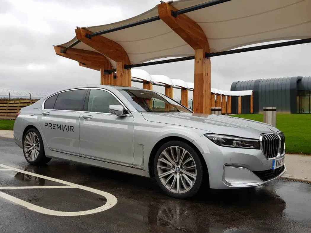 Chauffer driven car transfers at luxury airport lounge, PremiAir in Manchester Silver BMS outside an airport terminal building