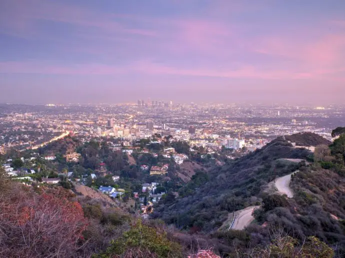 View of distant city skyline at dusk from a hillside