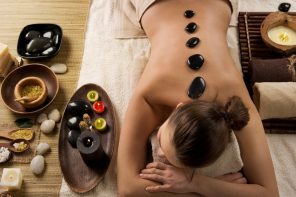Lady lying down in a spa having a hot stone massage