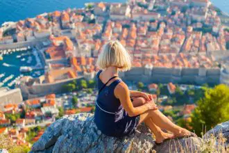 Tourist on hill overlooking Dubrovnik city in Croatia