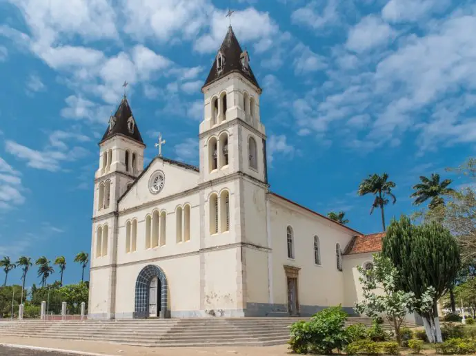 White cathedral with palm trees either side - one of the best places to visit on Sao Tome