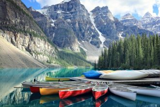 Mountain lake with red canoes in the foreground