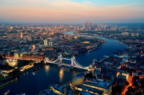 Aerial view of London looking down on a river with Tower Bridge over it