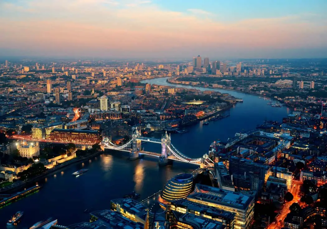 Aerial view of London looking down on a river with Tower Bridge over it