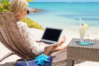 Digital Nomad - working on the beach with a laptop - remote working