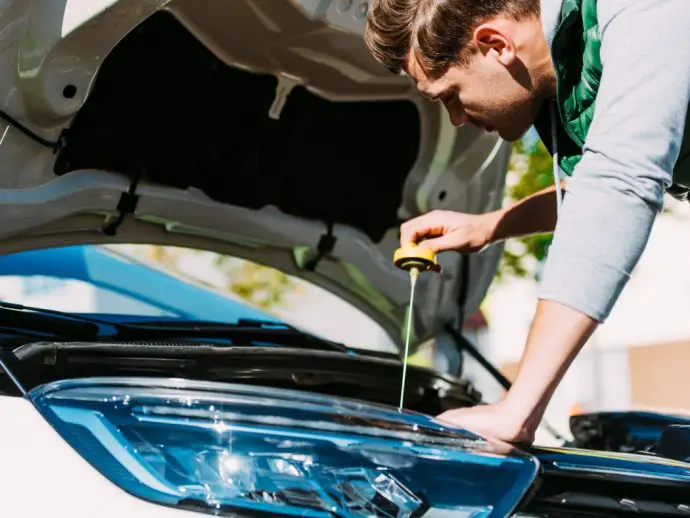 Checking car oil for a road trip