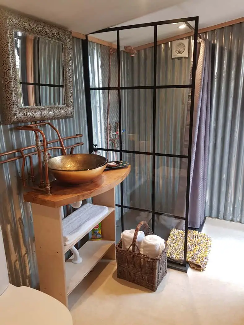 Ensuite bathroom with shower at Chui Treehouse at Wrinklers Wood Glamping - hot tub holidays in Cornwall
