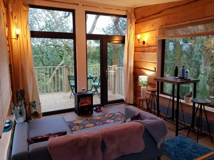 Evening inside Chui treehouse at Wrinklers Wood Glamping - hot tub holidays in Cornwall