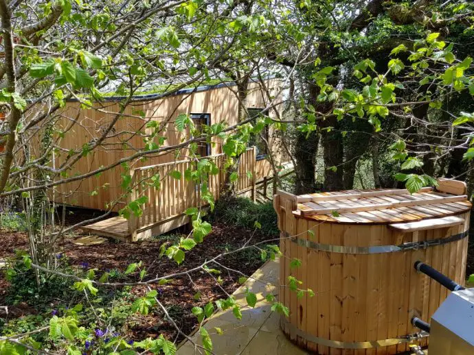 The hot tub outside Chui Treehouse at Wrinklers Wood Glamping - hot tub holidays in Cornwall