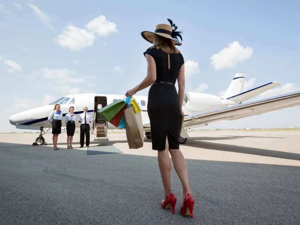 Lady wearing red heels outside a private jet