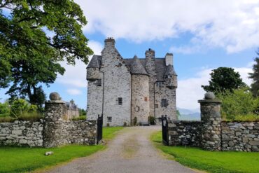 Turreted castle with stone gates to the front