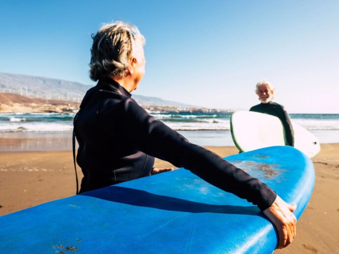 Senior couple surfing