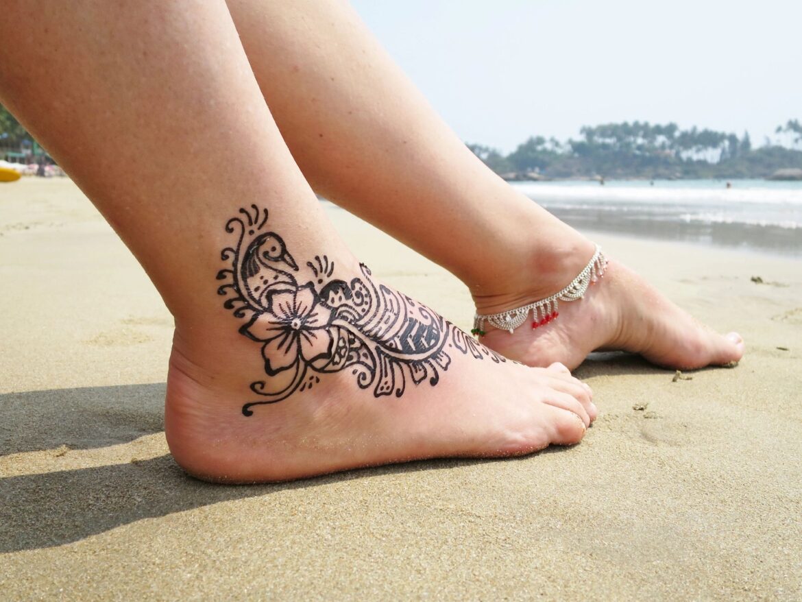 Ankle tattoo on beach