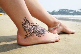 Ankle tattoo on beach