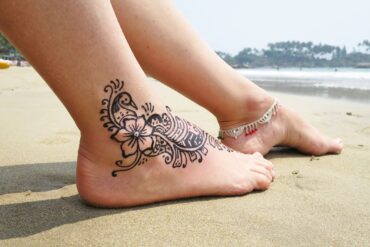 Ankle tattoo on beach