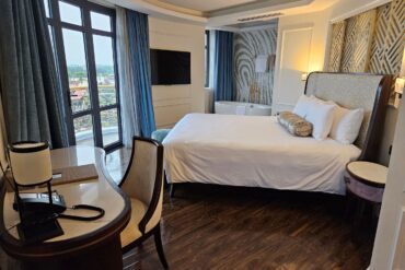 Bedroom with a bed, desk and window