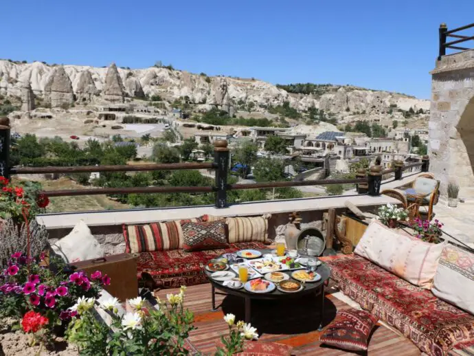 Terrace with cushions and tables overlooking rocky valley