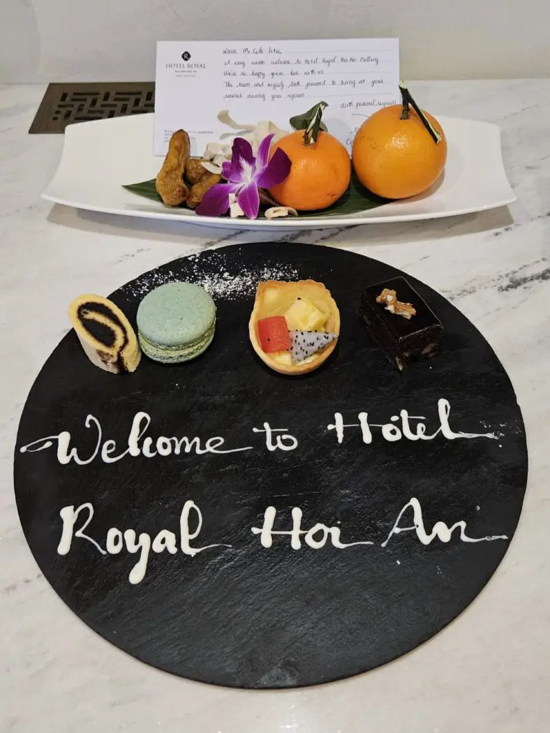 Slate board with fruit and cakes